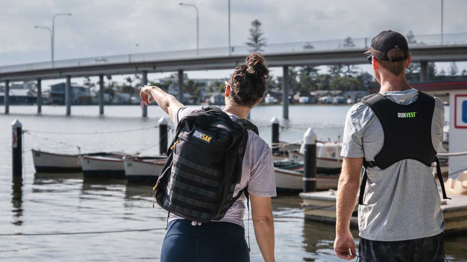 Man and woman wearing weighted backpack and weighted vest