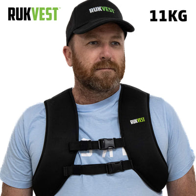 Man wearing a black 11KG UKVEST weighted vest on a white background