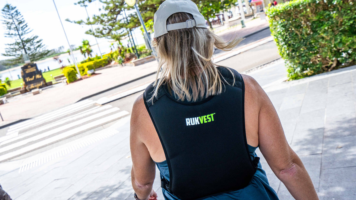 Woman wearing a black Rukvest vest on a city street.