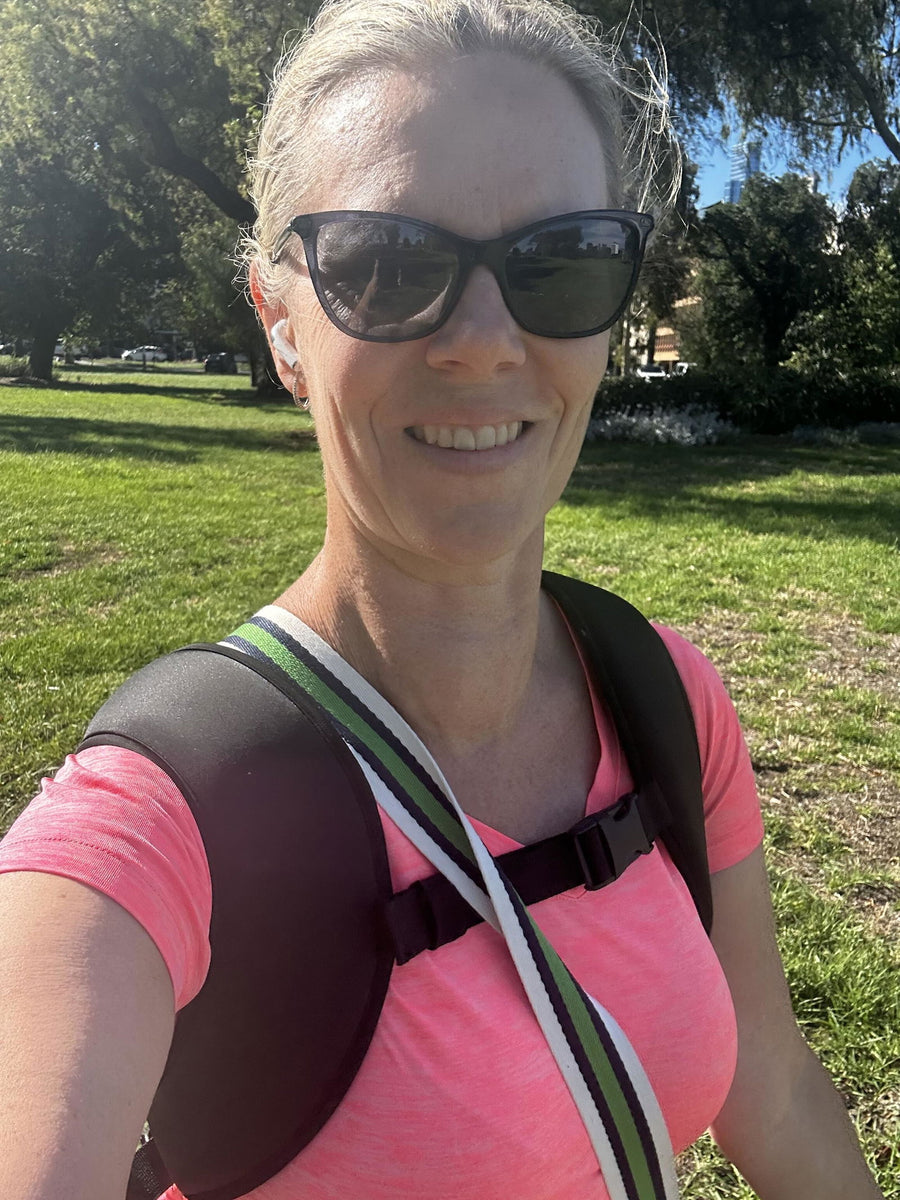 Fleur smiling on a walk in the park wearing her RUKVEST