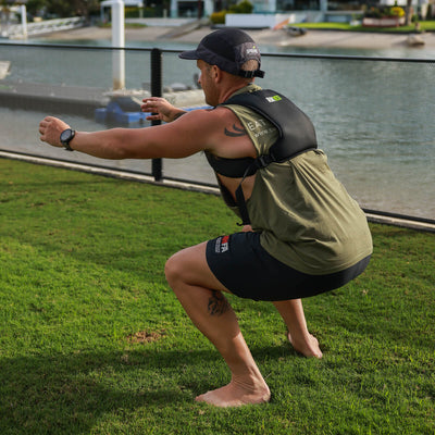 Person exercising outdoors on grass with a RUKVEST